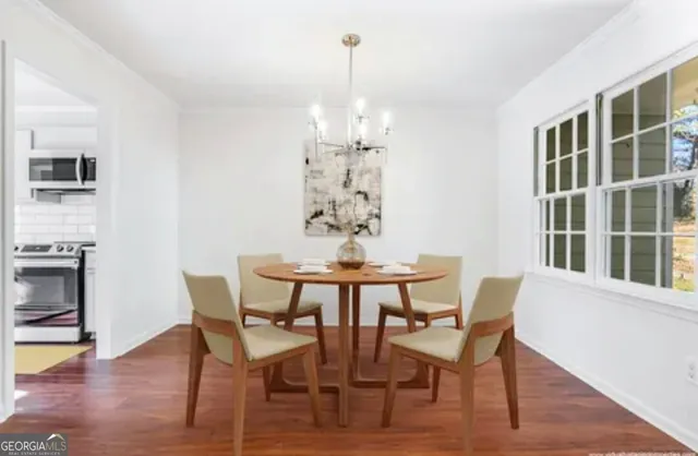 a view of a dining room with furniture window and wooden floor