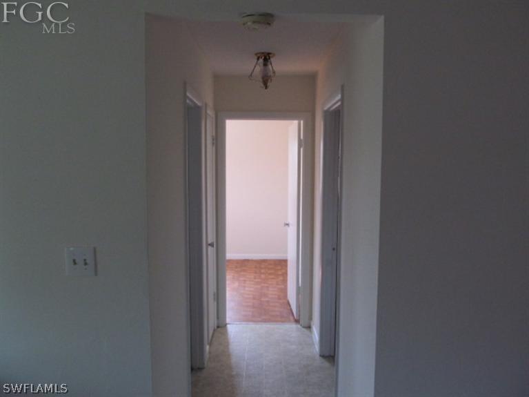 106 Georgia Road Lehigh Acres, FL 33936 - Photo 6 of 14 a view of a hallway to the door