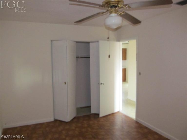 106 Georgia Road Lehigh Acres, FL 33936 - Photo 8 of 14 a view of an empty room and a chandelier fan