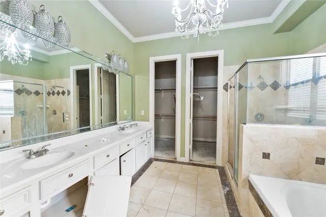 a spacious bathroom with a double vanity sink mirror and shower
