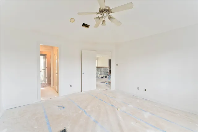 a view of a room with a ceiling fan