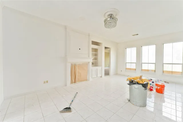 a view of a livingroom with a ceiling fan and window