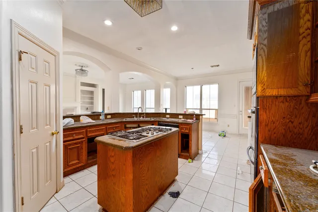 a kitchen with stainless steel appliances granite countertop a stove a sink and a refrigerator