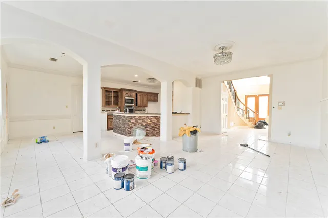 a hallway with a couch and chandelier