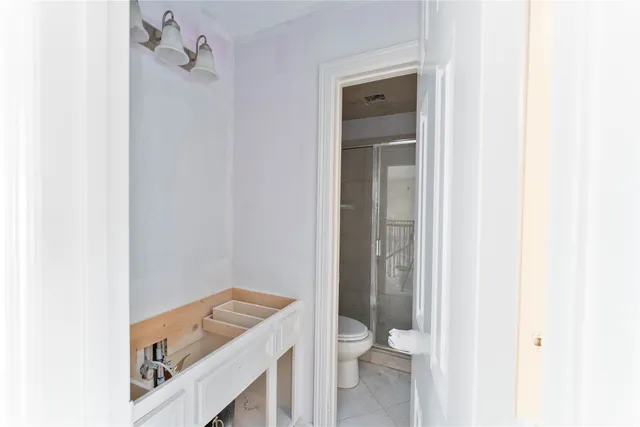 a bathroom with a toilet sink and shower