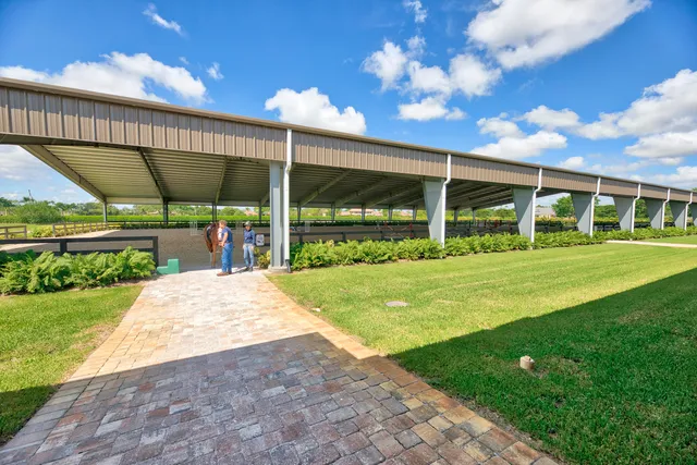 a view of a house with a big yard and potted plants