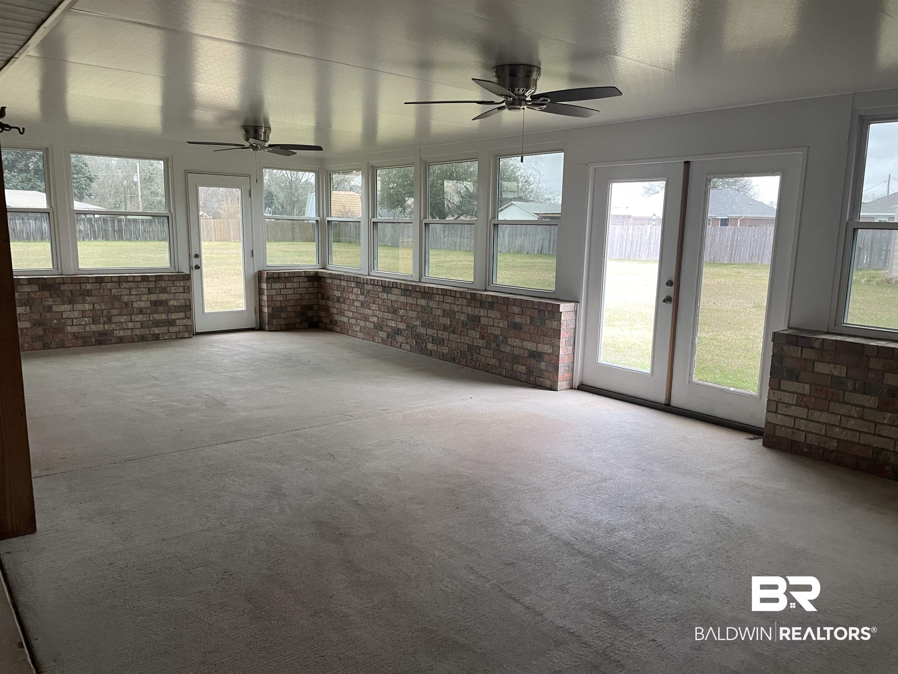 23575 Fountain Street Robertsdale, AL 36567 - Photo 15 of 19 Unfurnished sunroom with ceiling fan and french doors