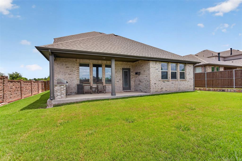 1002 Coppersmith Way Forney, TX 75126 - Photo 34 of 39 a view of a house with a garden and porch