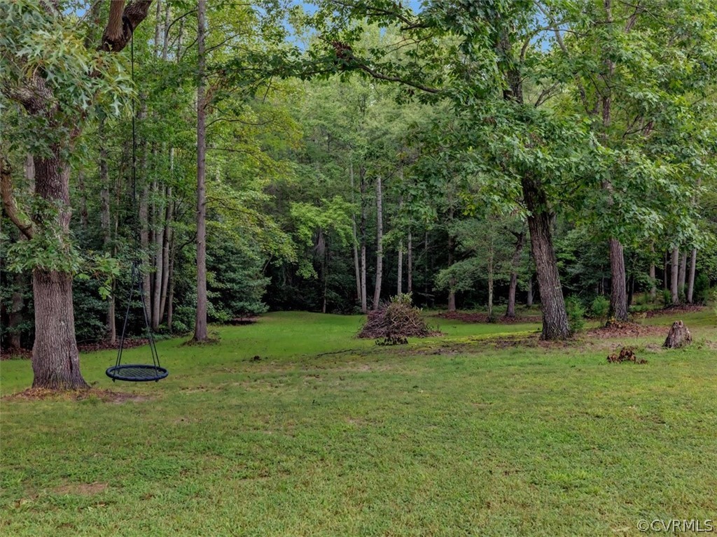 5900 Moseley Road Moseley, VA 23120 - Photo 5 of 45 a view of a backyard with a garden and entertaining space