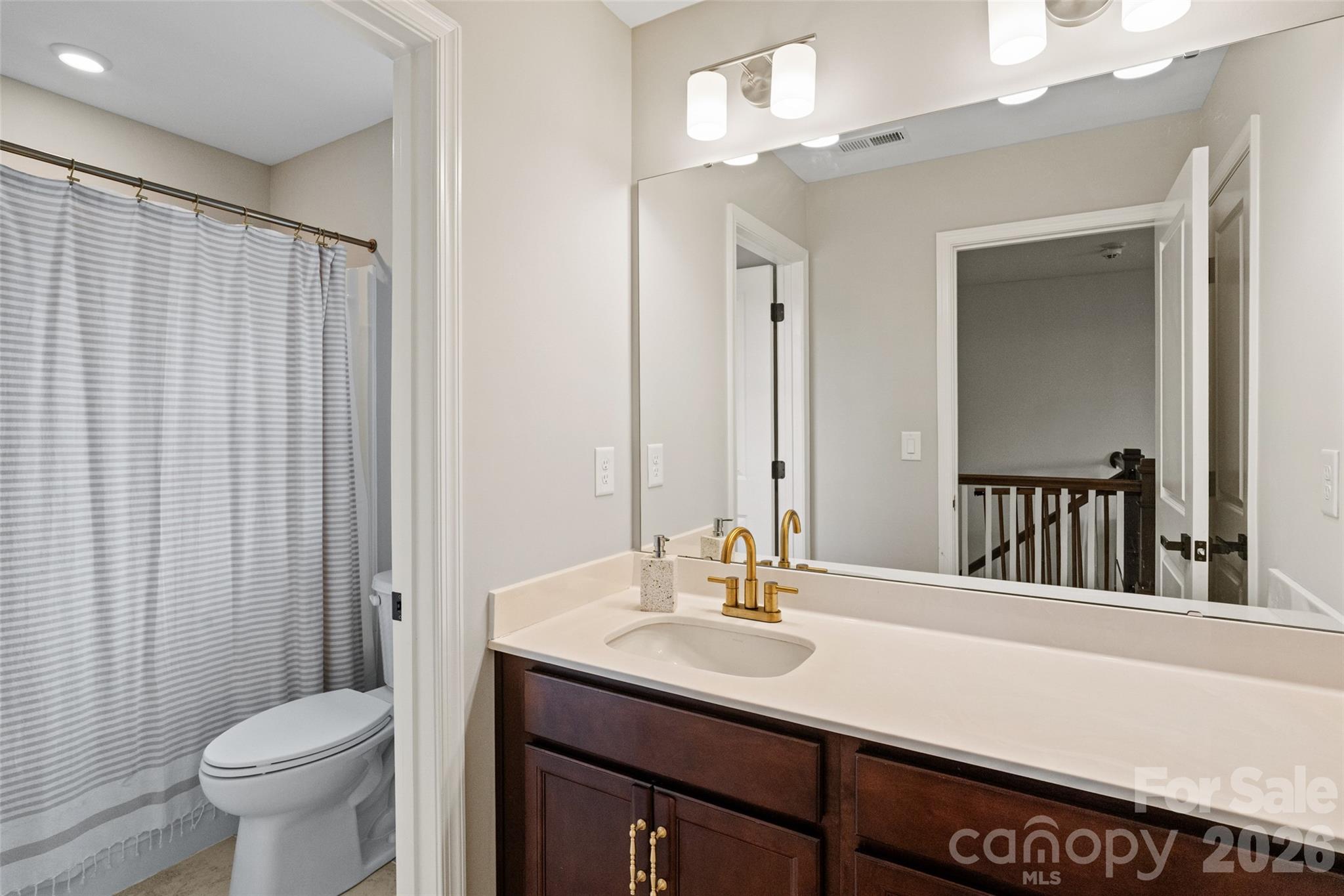 1350 Fishing Creek Road Clover, SC 29710 - Photo 31 of 47 a bathroom with a sink a toilet and a mirror