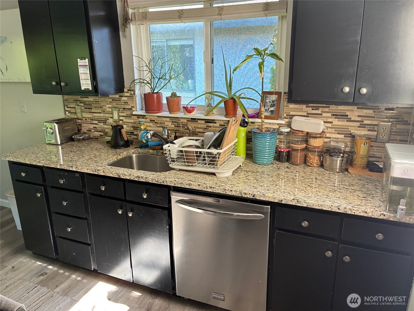 824 Northwest 64th Street Seattle, WA 98107 - Photo 7 of 7 a bathroom with a granite countertop double vanity sink and a mirror