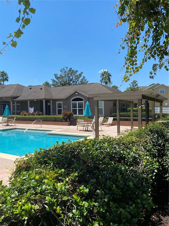 404 Summit Ridge Place, Unit 302 Longwood, FL 32779 - Photo 11 of 13 a front view of a building with a garden