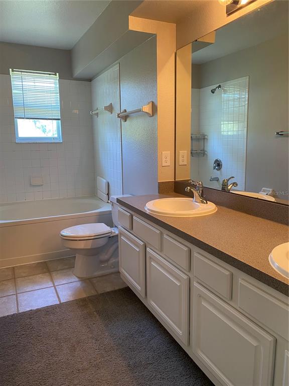 404 Summit Ridge Place, Unit 302 Longwood, FL 32779 - Photo 5 of 13 a bathroom with a double vanity sink toilet and a tub