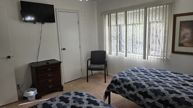 a bedroom with a bed and flat screen tv