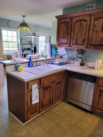 a kitchen with a stove a sink and a mirror