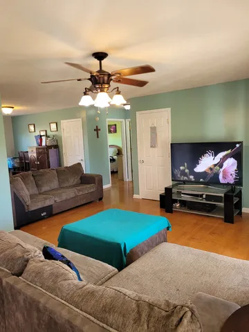 a view of a dining room with furniture and chandelier