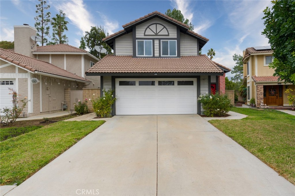 a front view of a house with a yard and garage