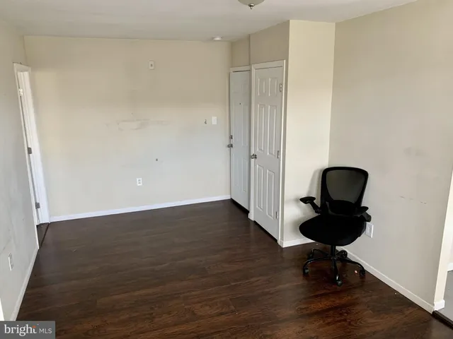 a view of a workspace room with wooden floor