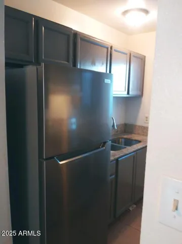 a kitchen with stainless steel appliances granite countertop a sink and a stove