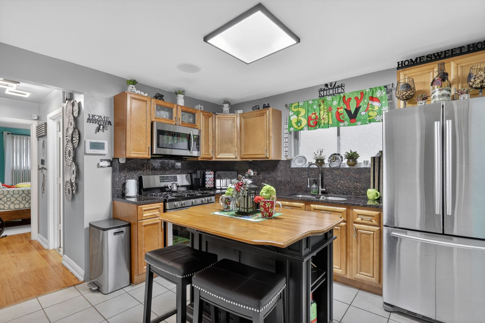 3446 West 74th Street Chicago, IL 60629 - Photo 6 of 30 a kitchen with a refrigerator a stove a sink and a microwave