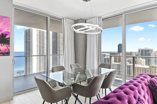 a living room with furniture and a floor to ceiling window