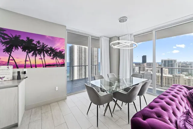a view of a dining room with furniture and chandelier