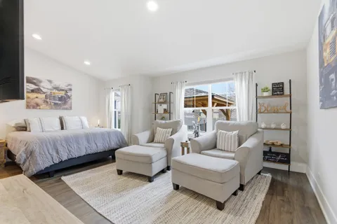 a spacious bedroom with a bed and a couch