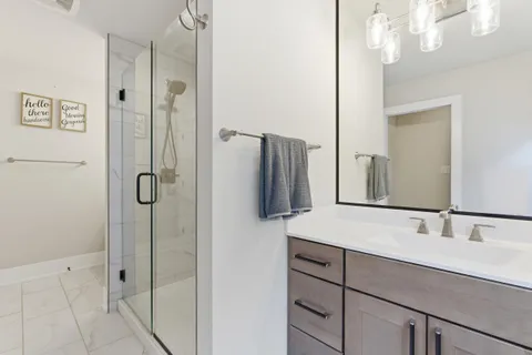 a bathroom with a shower and a glass door
