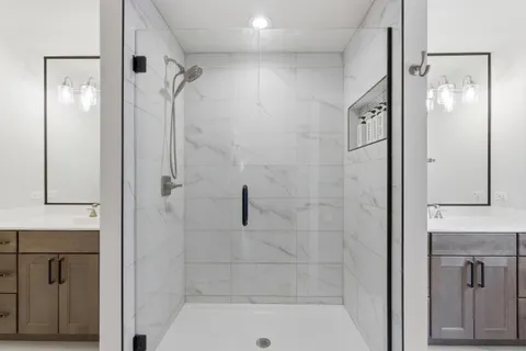 a bathroom with a shower sink and mirror