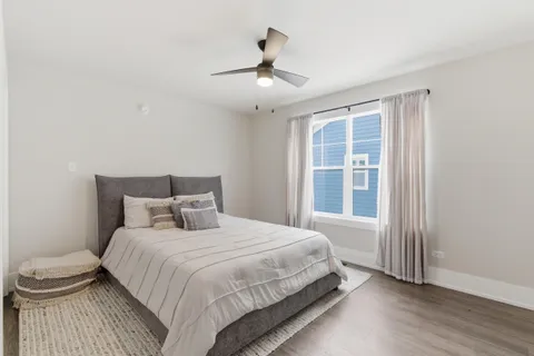 a bedroom with a large bed and a chandelier