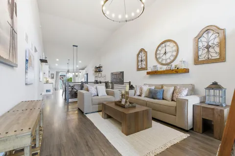 a living room with fireplace furniture and a wooden floor
