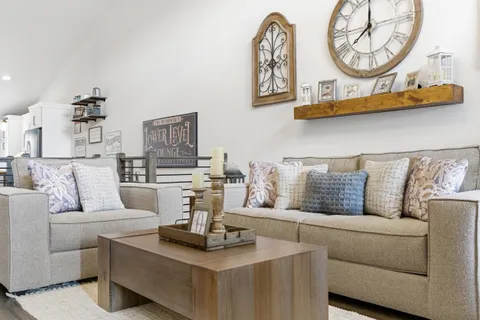 a living room with furniture a mirror and wall painting