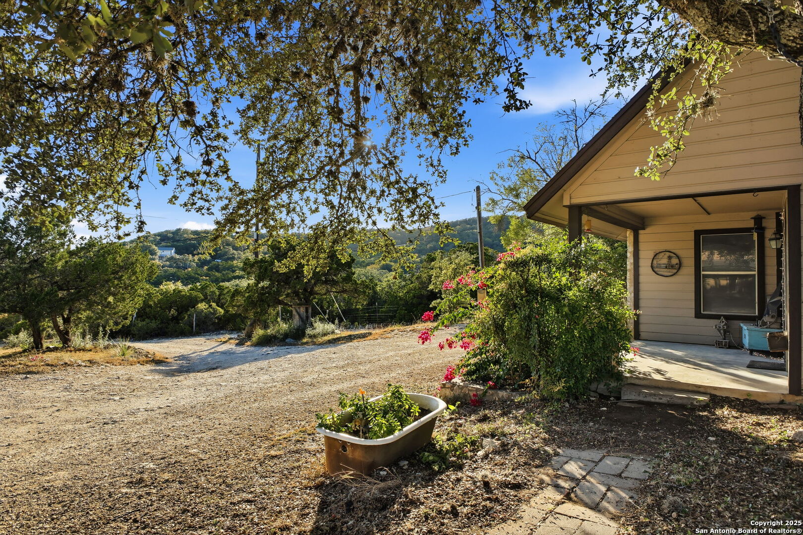 18668 Bandera Road Helotes, TX 78023 - Photo 21 of 52 a backyard of a house with lots of green space
