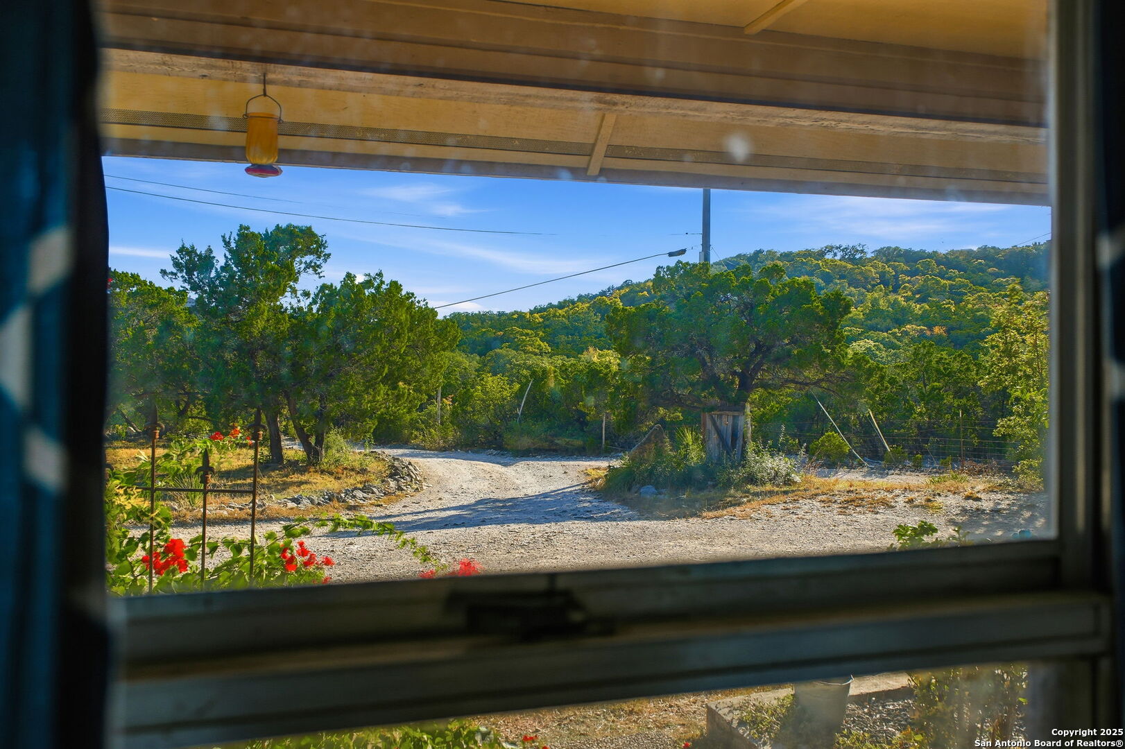 18668 Bandera Road Helotes, TX 78023 - Photo 22 of 52 a view of a yard from a window