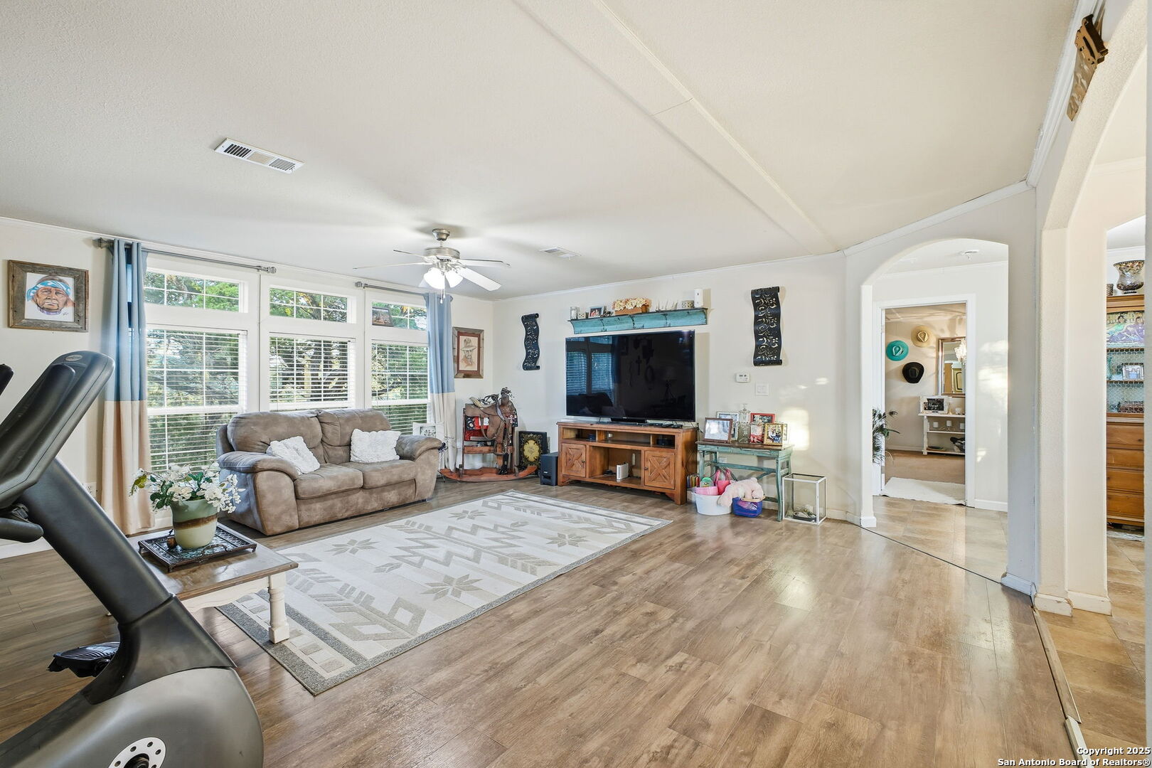 18668 Bandera Road Helotes, TX 78023 - Photo 31 of 52 a living room with furniture and a flat screen tv