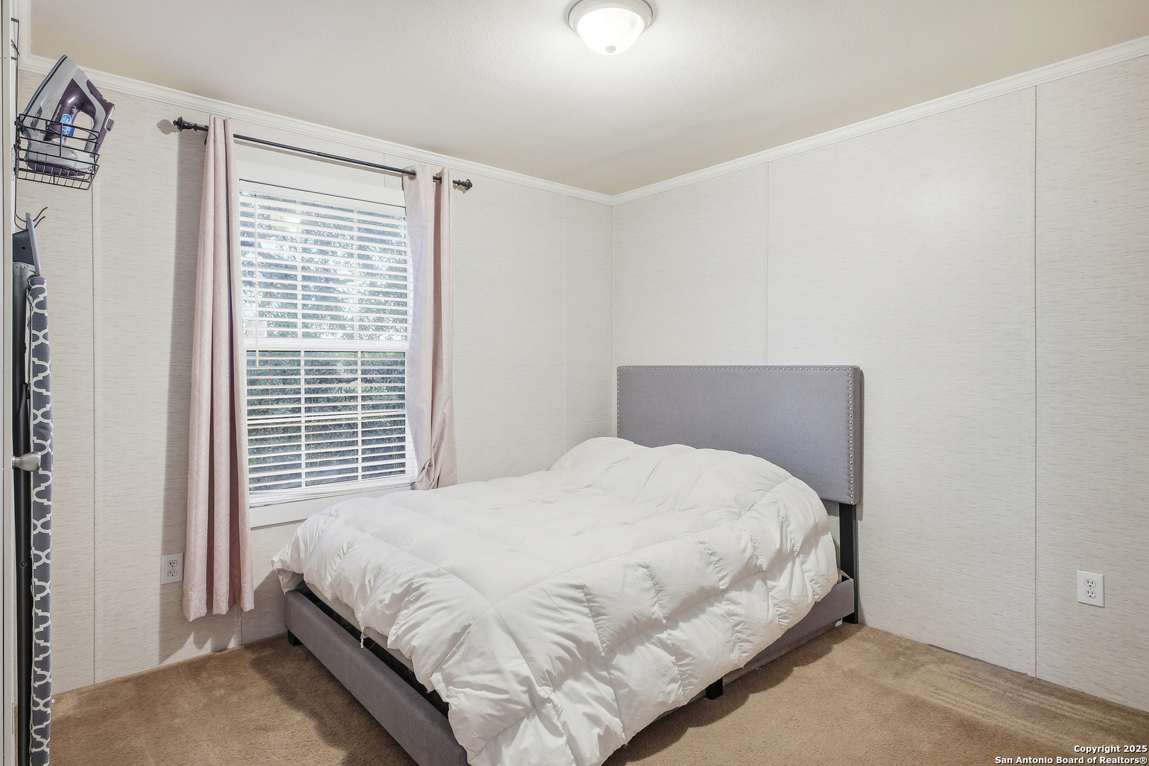 18668 Bandera Road Helotes, TX 78023 - Photo 36 of 52 a large bed sitting in a bedroom next to a window