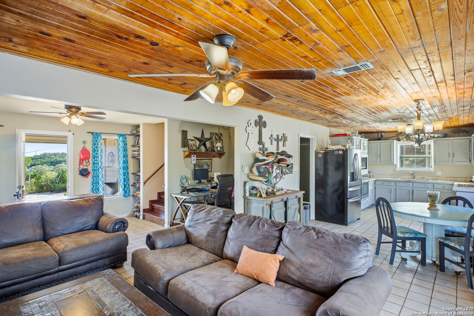 18668 Bandera Road Helotes, TX 78023 - Photo 40 of 52 a living room with furniture and a chandelier