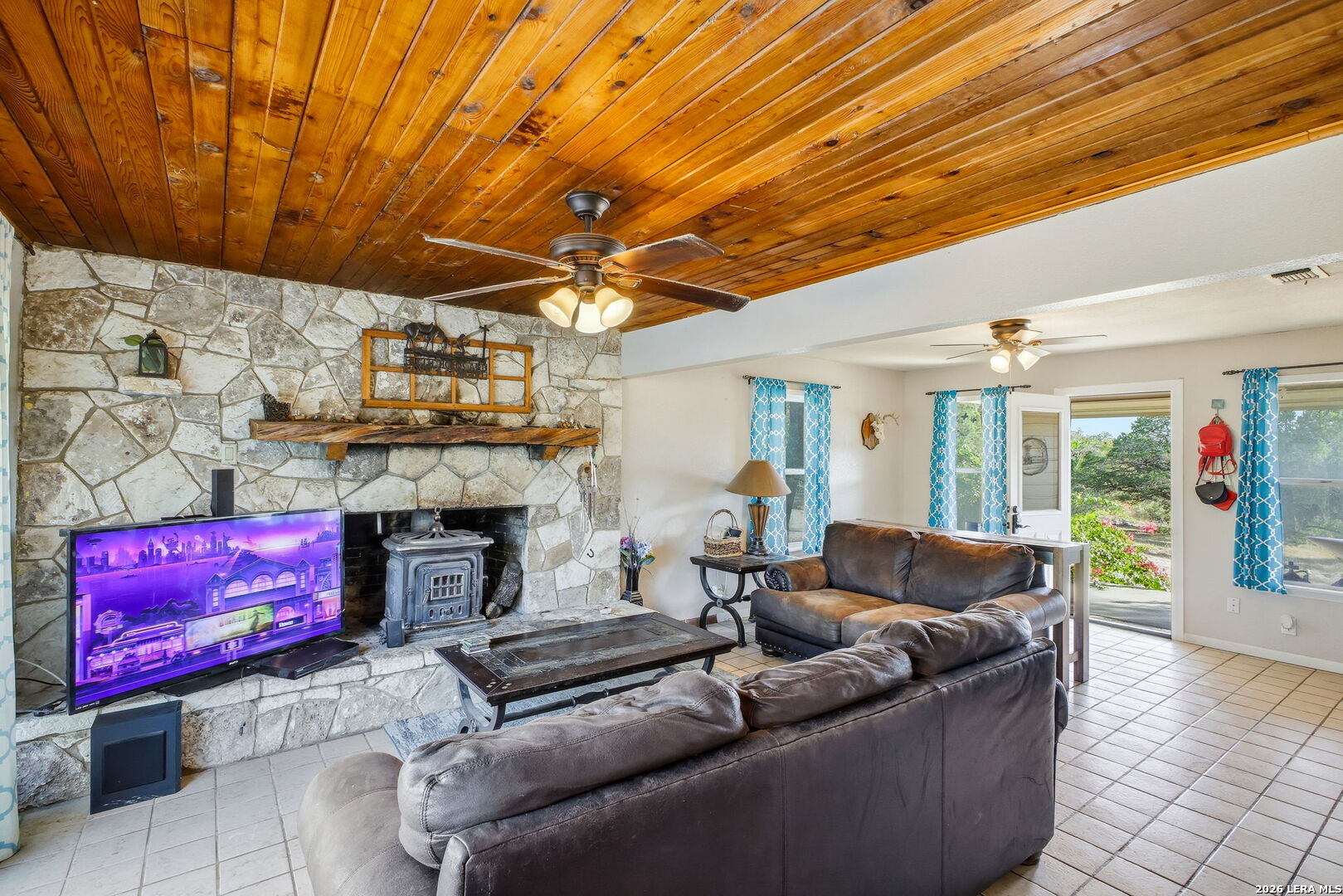 18668 Bandera Road Helotes, TX 78023 - Photo 41 of 52 a living room with furniture and a fireplace