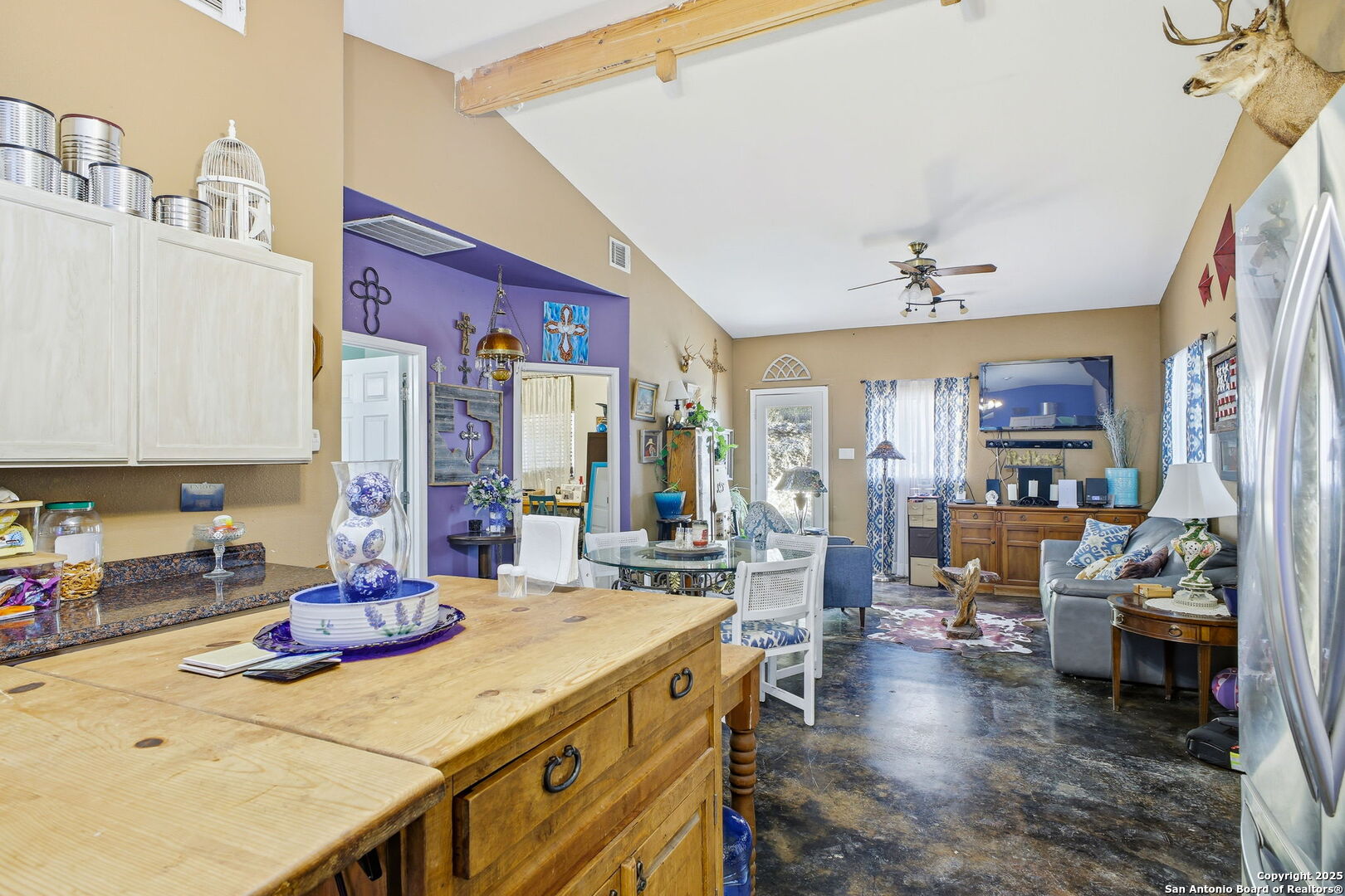 18668 Bandera Road Helotes, TX 78023 - Photo 48 of 52 a large kitchen with sink a refrigerator and chairs
