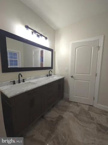 a bathroom with a double vanity sink and mirror