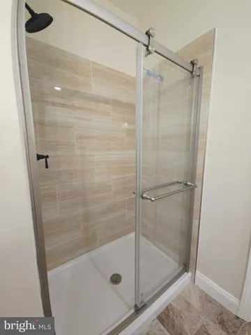 a bathroom with a glass shower door