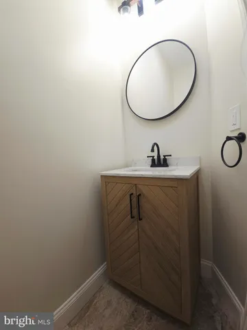 a bathroom with a sink and mirror