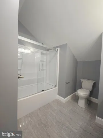 a bathroom with a shower and a toilet