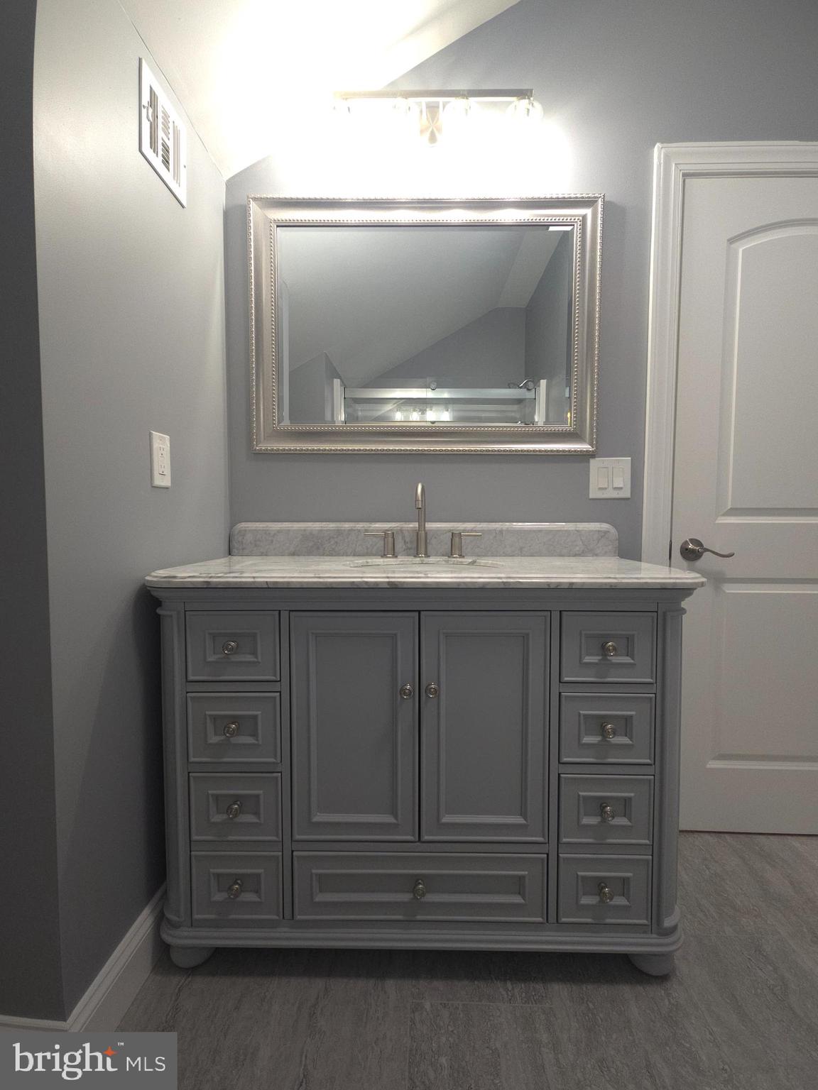 1015 Chambers Street Harrisburg, PA 17113 - Photo 17 of 23 a bathroom with a sink a vanity and a mirror