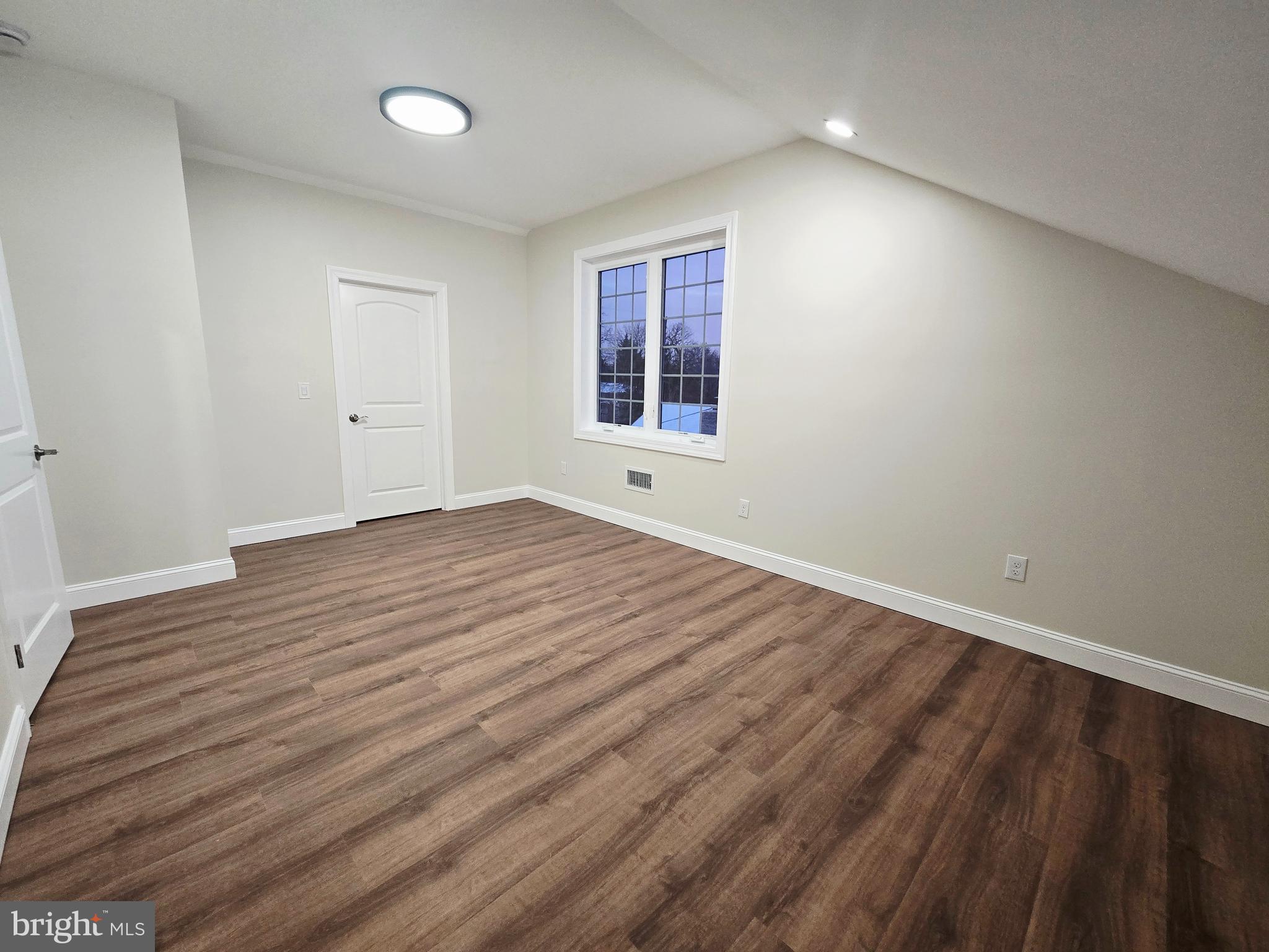 1015 Chambers Street Harrisburg, PA 17113 - Photo 20 of 23 a view of an empty room with wooden floor and a window