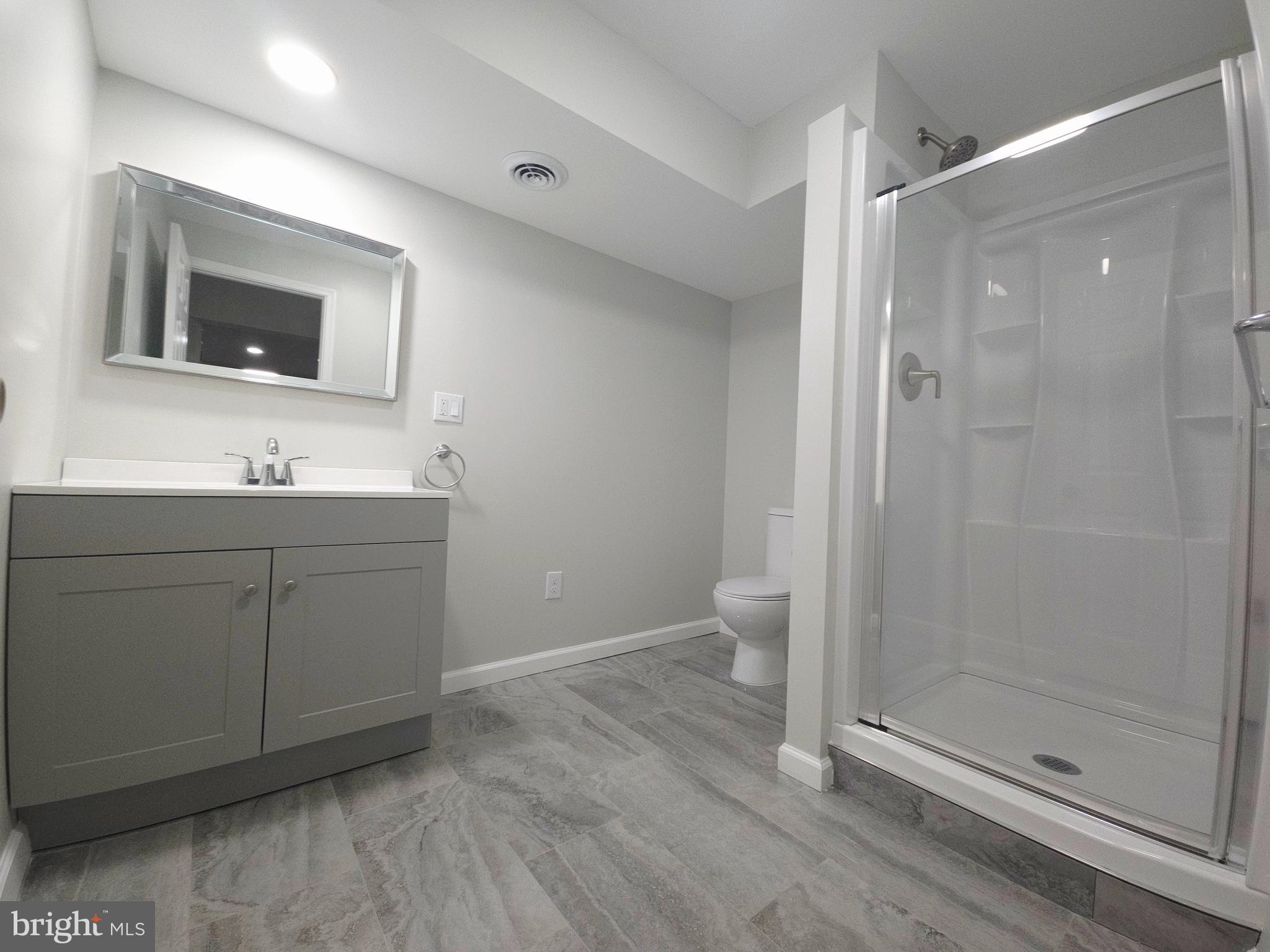 1015 Chambers Street Harrisburg, PA 17113 - Photo 23 of 23 a bathroom with a toilet a sink and mirror