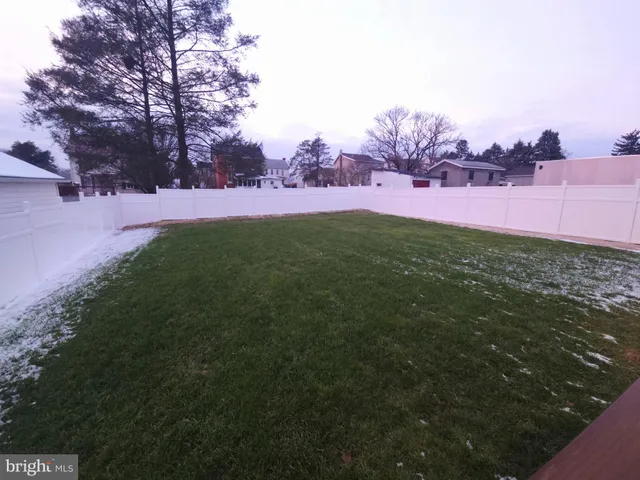 a view of a field with trees around