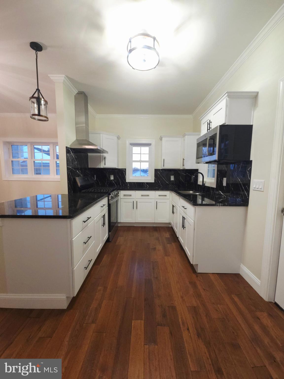 1015 Chambers Street Harrisburg, PA 17113 - Photo 4 of 23 a kitchen with cabinets a sink and appliances