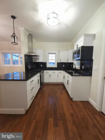 a kitchen with cabinets a sink and appliances