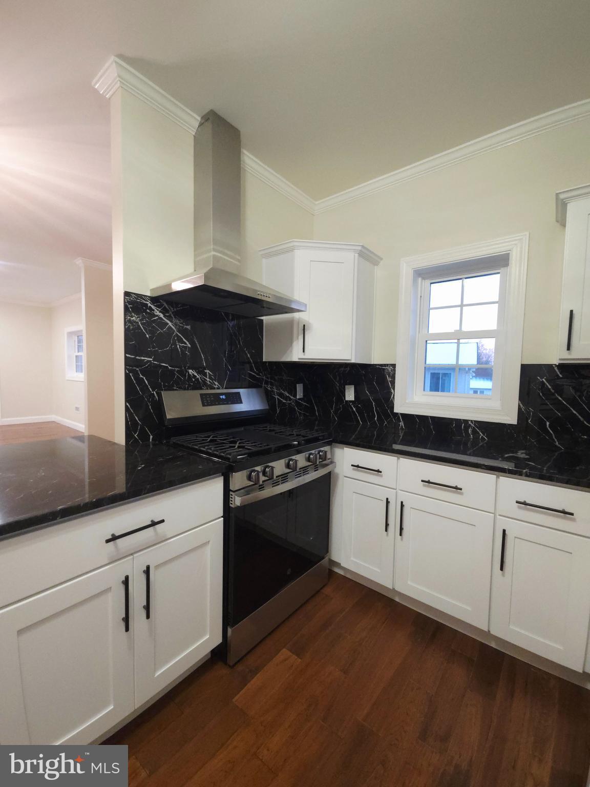 1015 Chambers Street Harrisburg, PA 17113 - Photo 5 of 23 a kitchen with granite countertop white cabinets and black appliances